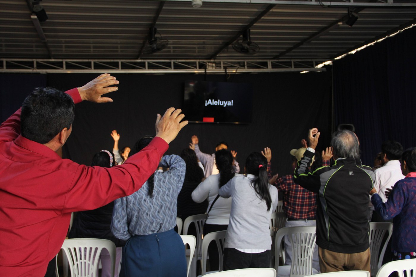 Congregación adorando con la pantalla de visuales mostrando ¡Aleluya!